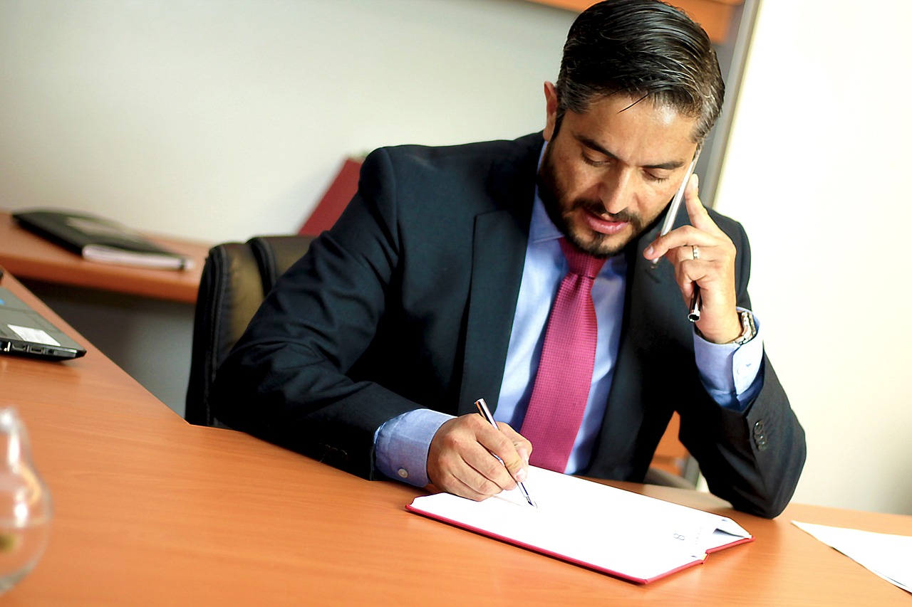 an image of a commercial property solicitor looking over some papers and on the phone