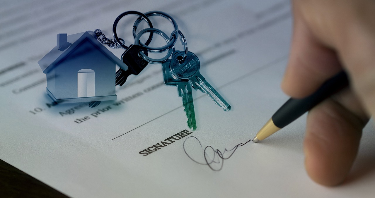an image of a property sale contract being signed
